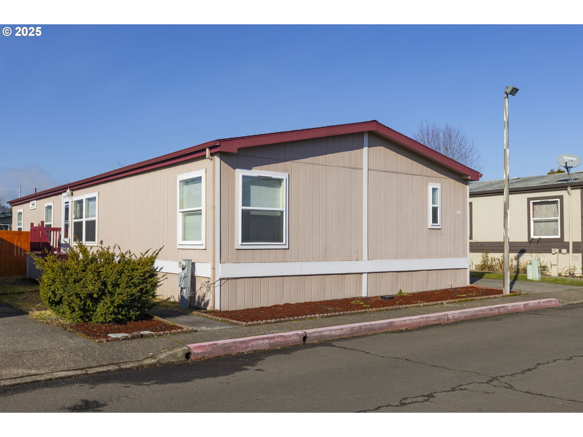 1949 Southeast Palmquist Road, Unit 80 Gresham, OR 97080 - Photo 2 of 35 a front view of a house with a yard