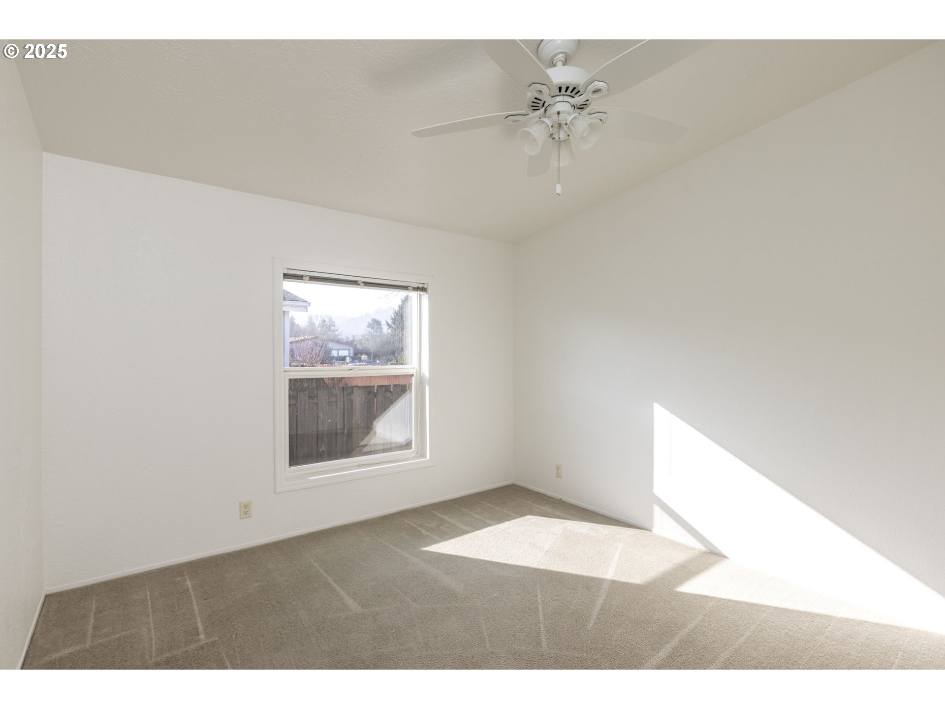 1949 Southeast Palmquist Road, Unit 80 Gresham, OR 97080 - Photo 23 of 35 a view of an empty room with a window