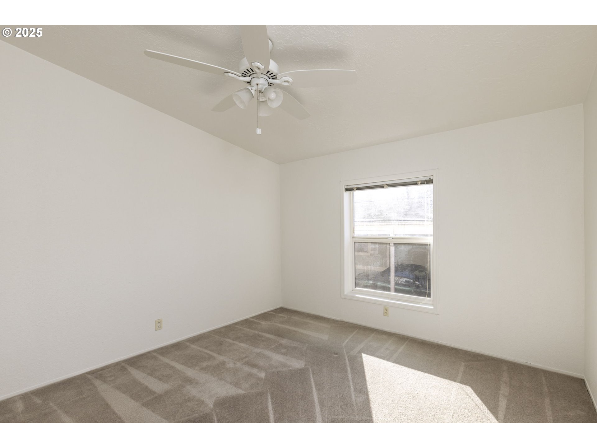 1949 Southeast Palmquist Road, Unit 80 Gresham, OR 97080 - Photo 25 of 35 an empty room with windows and fan