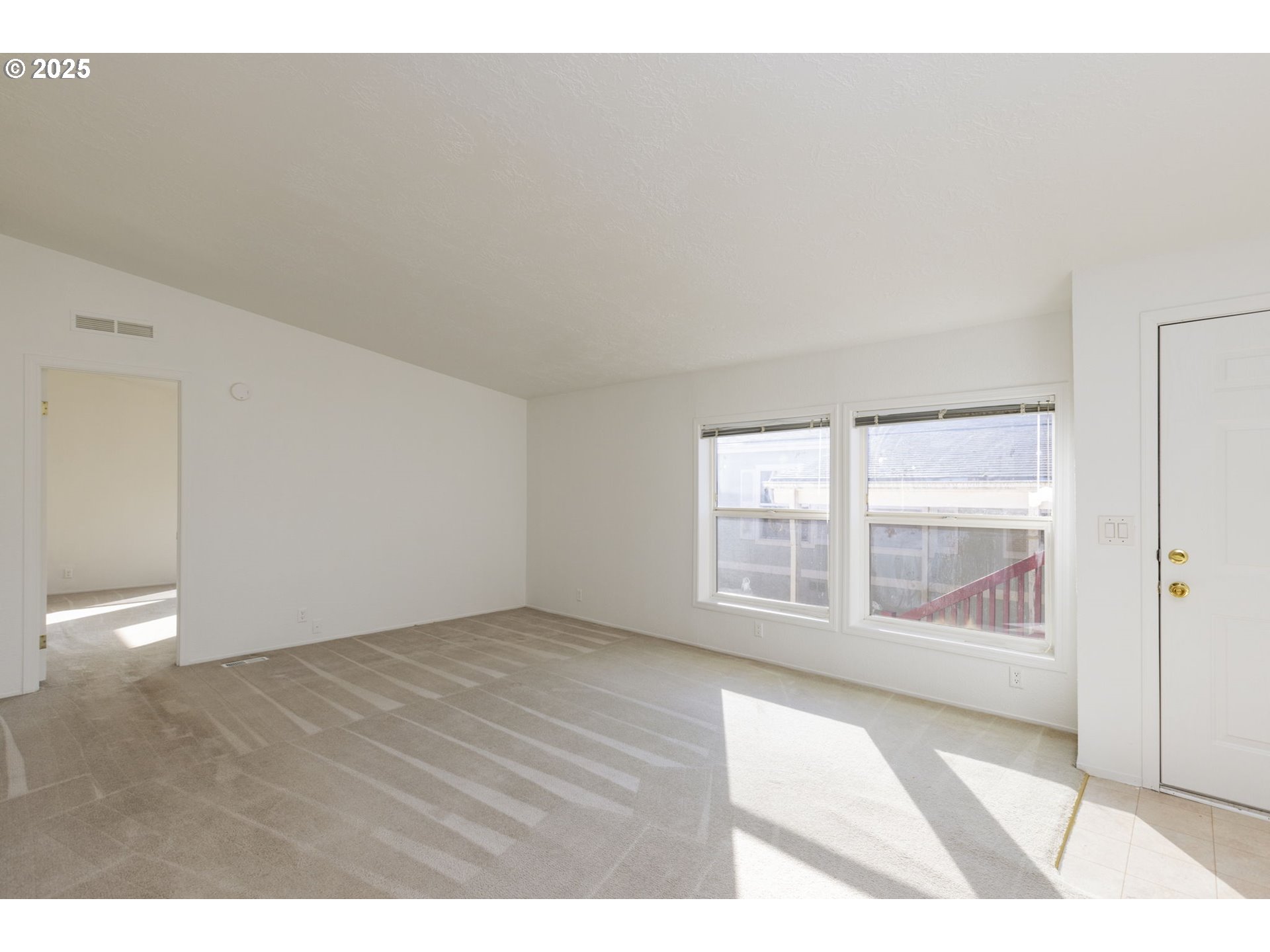 1949 Southeast Palmquist Road, Unit 80 Gresham, OR 97080 - Photo 3 of 35 a view of an empty room with a window