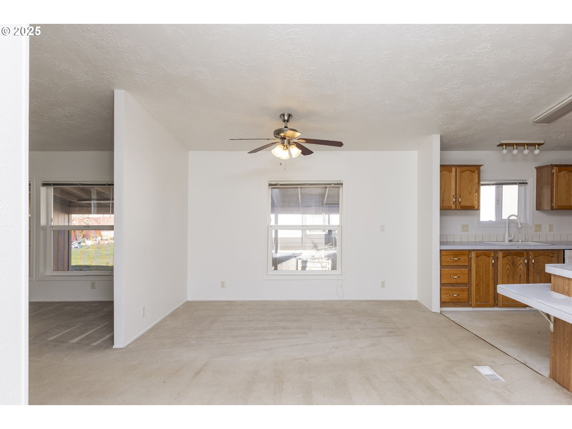 1949 Southeast Palmquist Road, Unit 80 Gresham, OR 97080 - Photo 7 of 35 a view of an empty room with a window