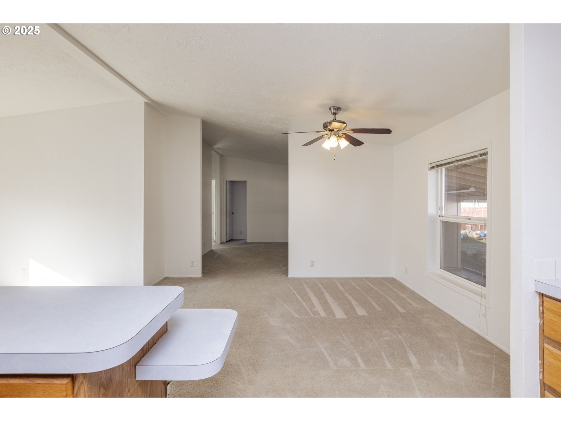 1949 Southeast Palmquist Road, Unit 80 Gresham, OR 97080 - Photo 8 of 35 a living room with furniture and a chandelier