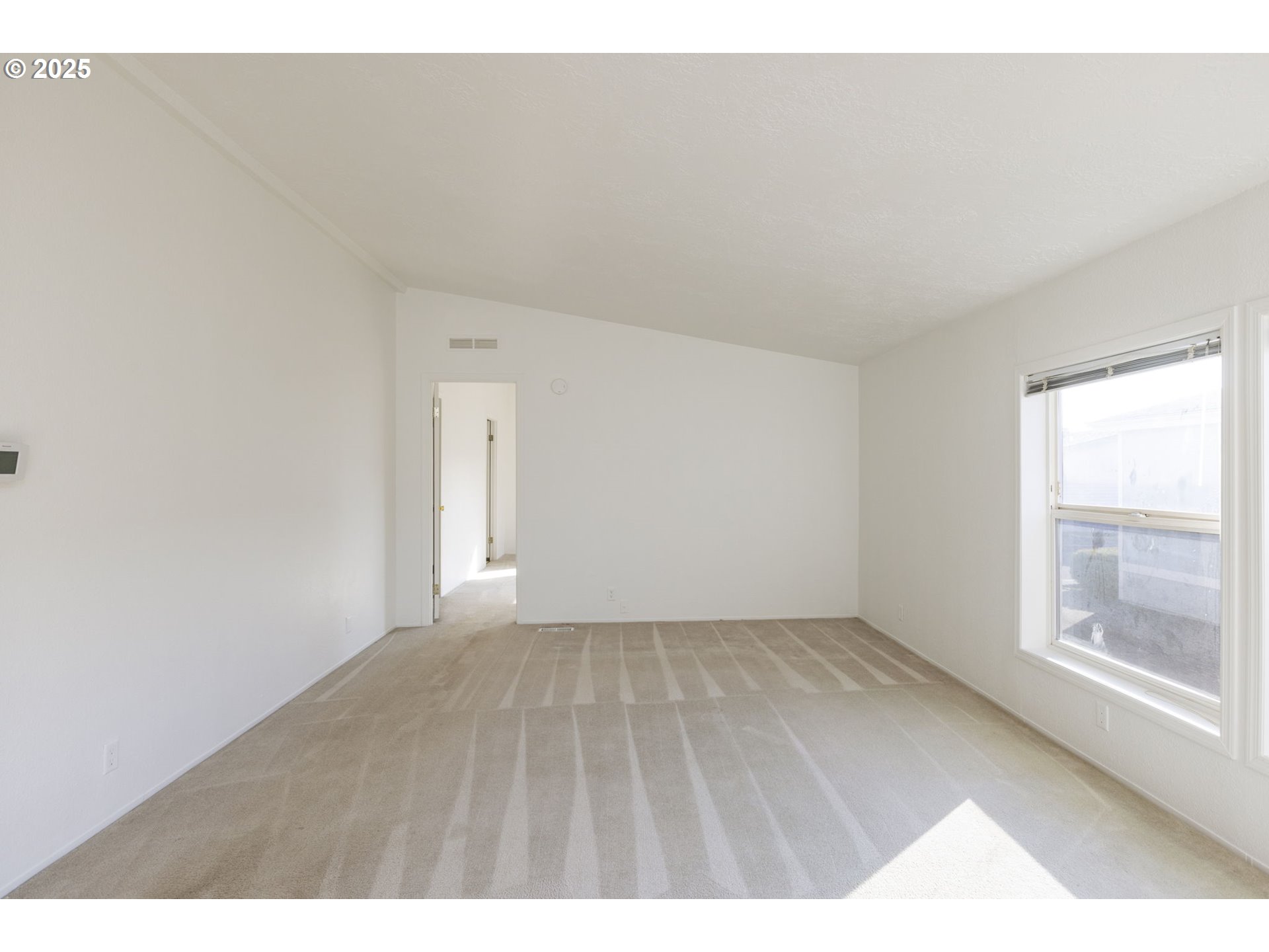 1949 Southeast Palmquist Road, Unit 80 Gresham, OR 97080 - Photo 9 of 35 a view of an empty room and window