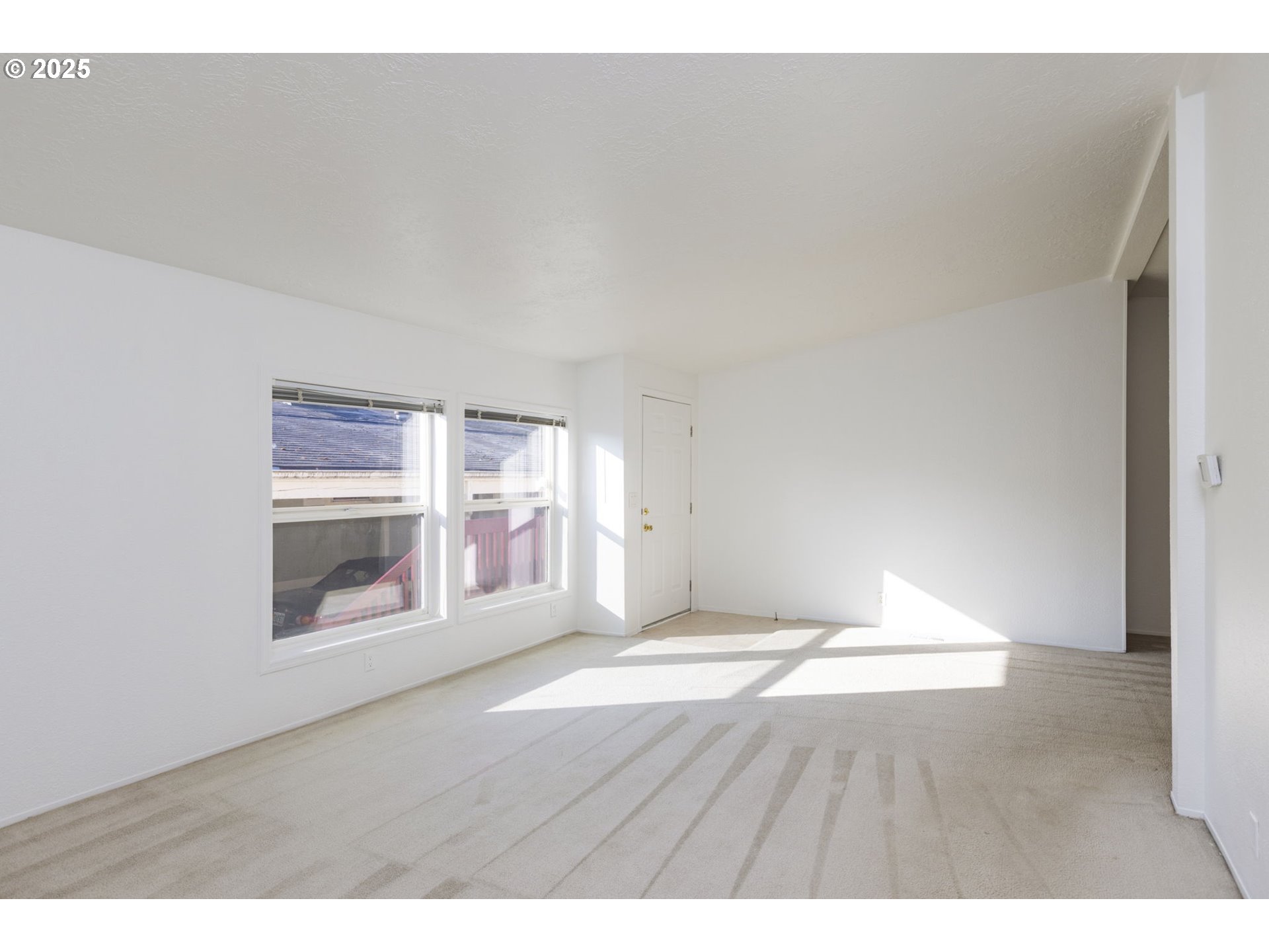 1949 Southeast Palmquist Road, Unit 80 Gresham, OR 97080 - Photo 10 of 35 a view of wooden floor and windows in a room