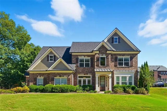 a front view of a house with a yard