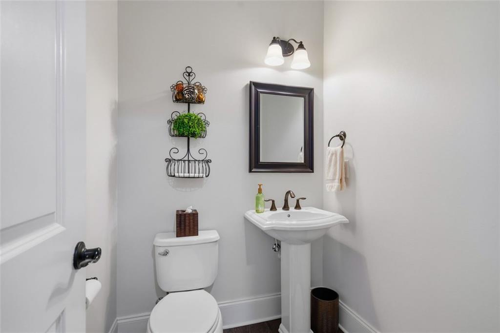 12115 Spence Way Alpharetta, GA 30004 - Photo 12 of 46 a bathroom with a toilet sink and mirror