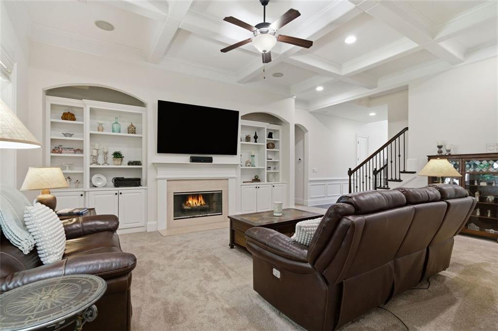 12115 Spence Way Alpharetta, GA 30004 - Photo 14 of 46 a living room with furniture a fireplace and a flat screen tv