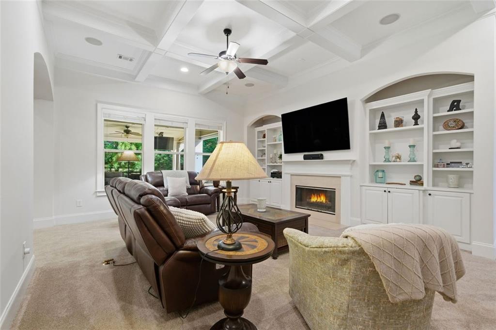 12115 Spence Way Alpharetta, GA 30004 - Photo 15 of 46 a living room with furniture a fireplace and a flat screen tv