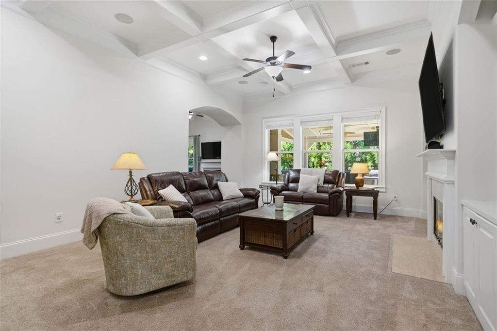 12115 Spence Way Alpharetta, GA 30004 - Photo 16 of 46 a living room with fireplace furniture and a flat screen tv