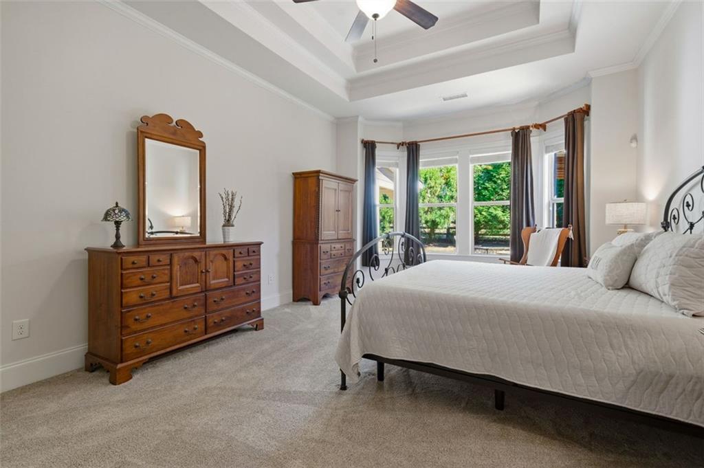 12115 Spence Way Alpharetta, GA 30004 - Photo 17 of 46 a bedroom with a bed dresser and a large mirror