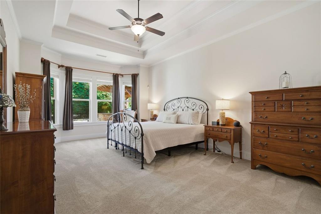 12115 Spence Way Alpharetta, GA 30004 - Photo 18 of 46 a spacious bedroom with a bed and a window