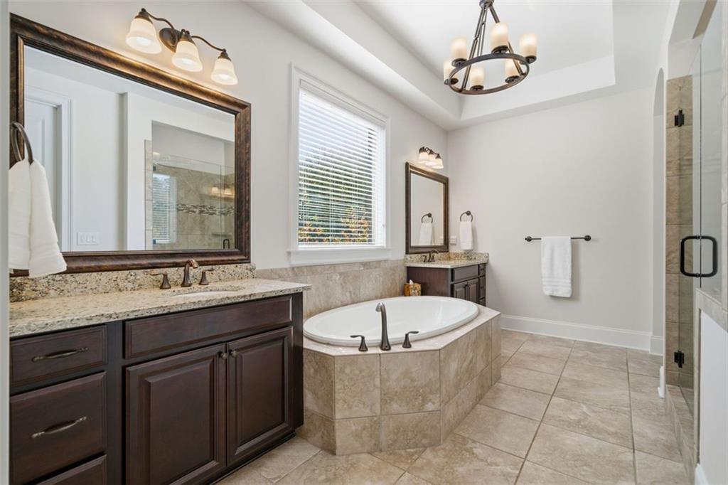 12115 Spence Way Alpharetta, GA 30004 - Photo 20 of 46 a bathroom with a tub sink and mirror