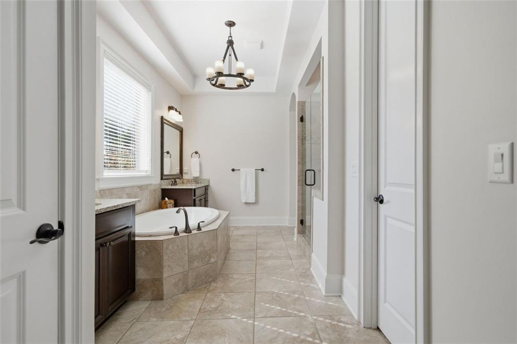 12115 Spence Way Alpharetta, GA 30004 - Photo 21 of 46 a bathroom with a bathtub a sink and a shower