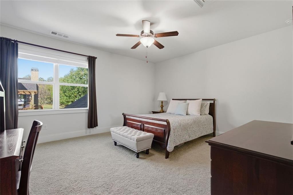 12115 Spence Way Alpharetta, GA 30004 - Photo 31 of 46 a spacious bedroom with a bed and a large window