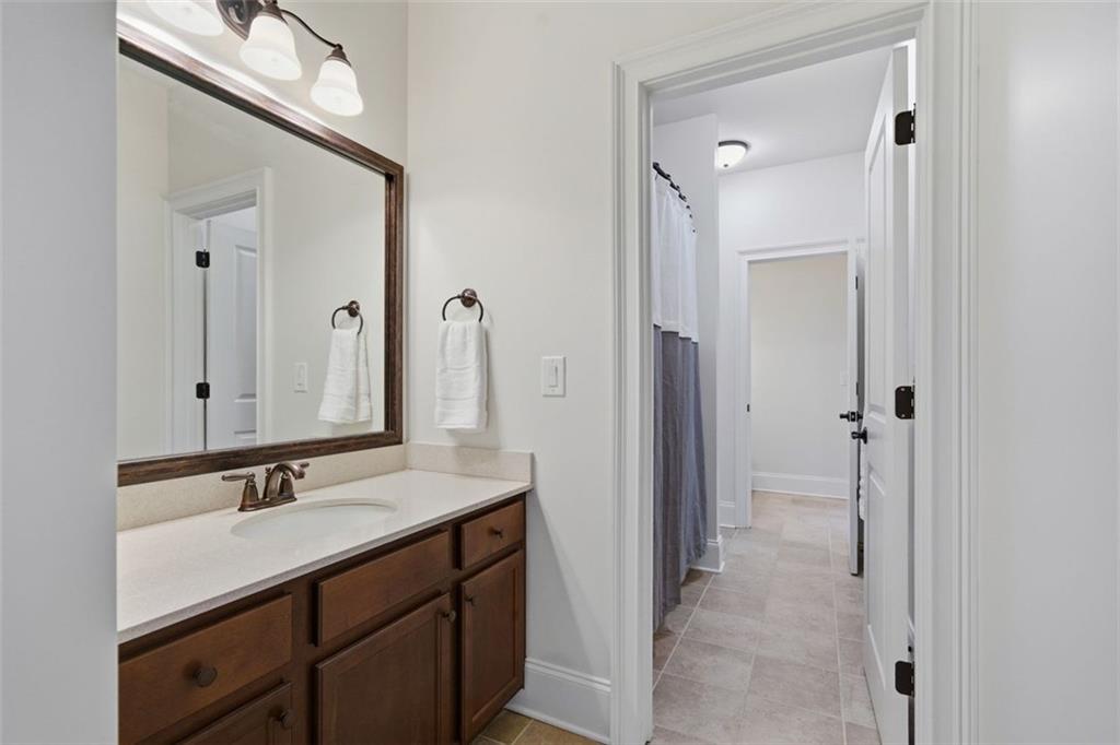 12115 Spence Way Alpharetta, GA 30004 - Photo 33 of 46 a bathroom with a sink vanity granite shower and a mirror