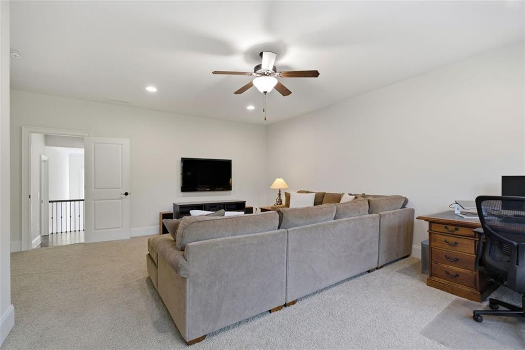 12115 Spence Way Alpharetta, GA 30004 - Photo 36 of 46 a living room with furniture and a flat screen tv