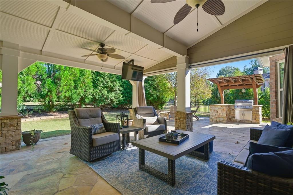 12115 Spence Way Alpharetta, GA 30004 - Photo 41 of 46 a living room with patio furniture and a garden