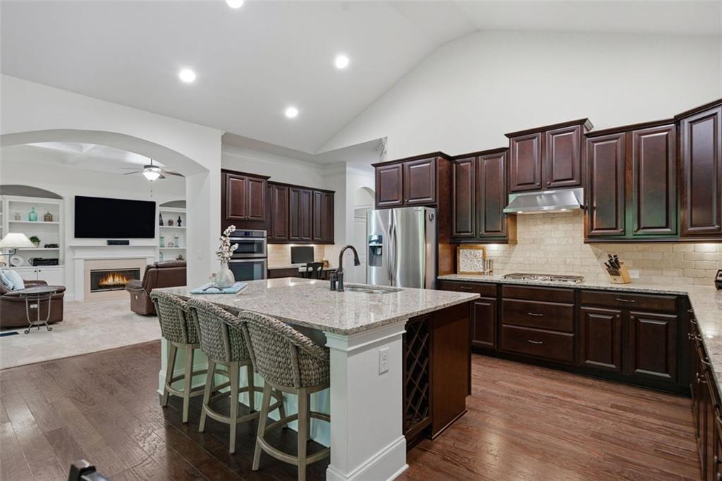 12115 Spence Way Alpharetta, GA 30004 - Photo 6 of 46 a kitchen with granite countertop a sink appliances and cabinets