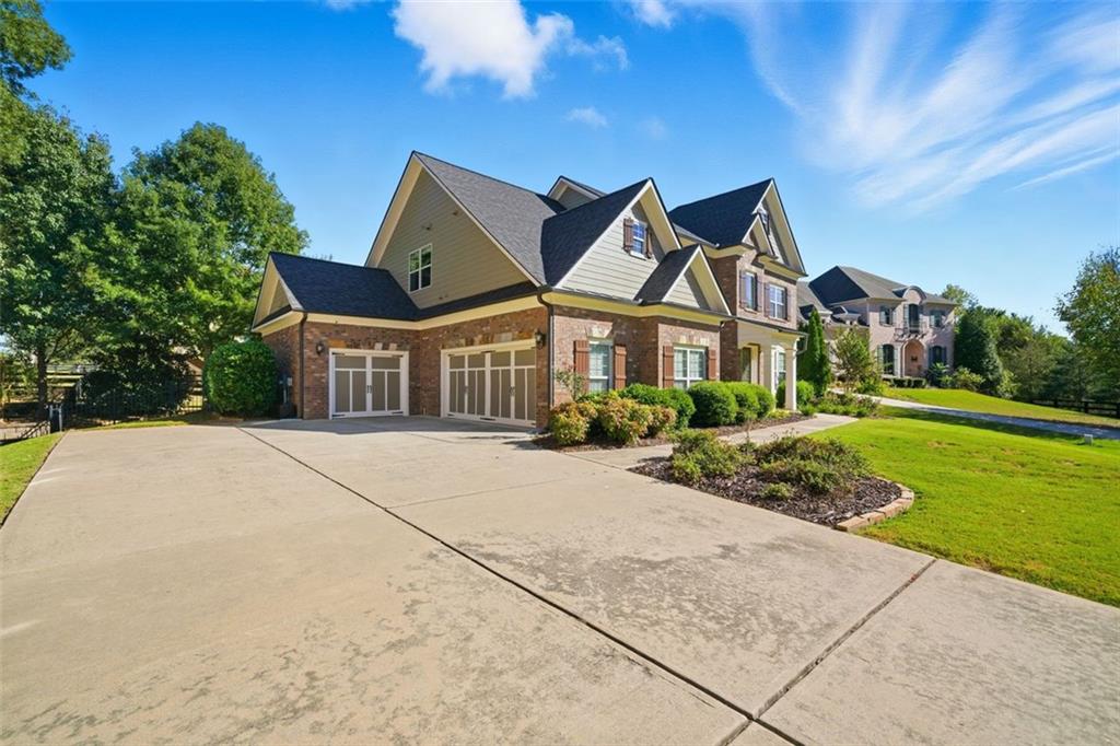 12115 Spence Way Alpharetta, GA 30004 - Photo 9 of 46 a front view of a house with a yard
