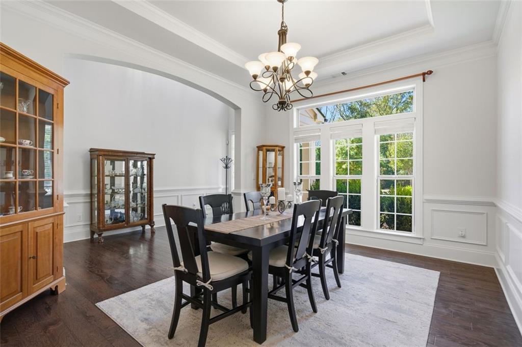 12115 Spence Way Alpharetta, GA 30004 - Photo 10 of 46 a view of a dining room with furniture a chandelier and wooden floor