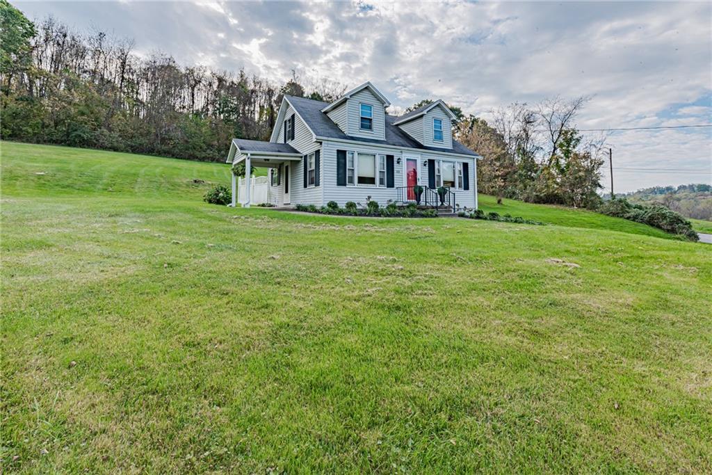 222 Maple Road Washington, PA 15301 - Photo 5 of 24 a view of a big house with a big yard and large trees