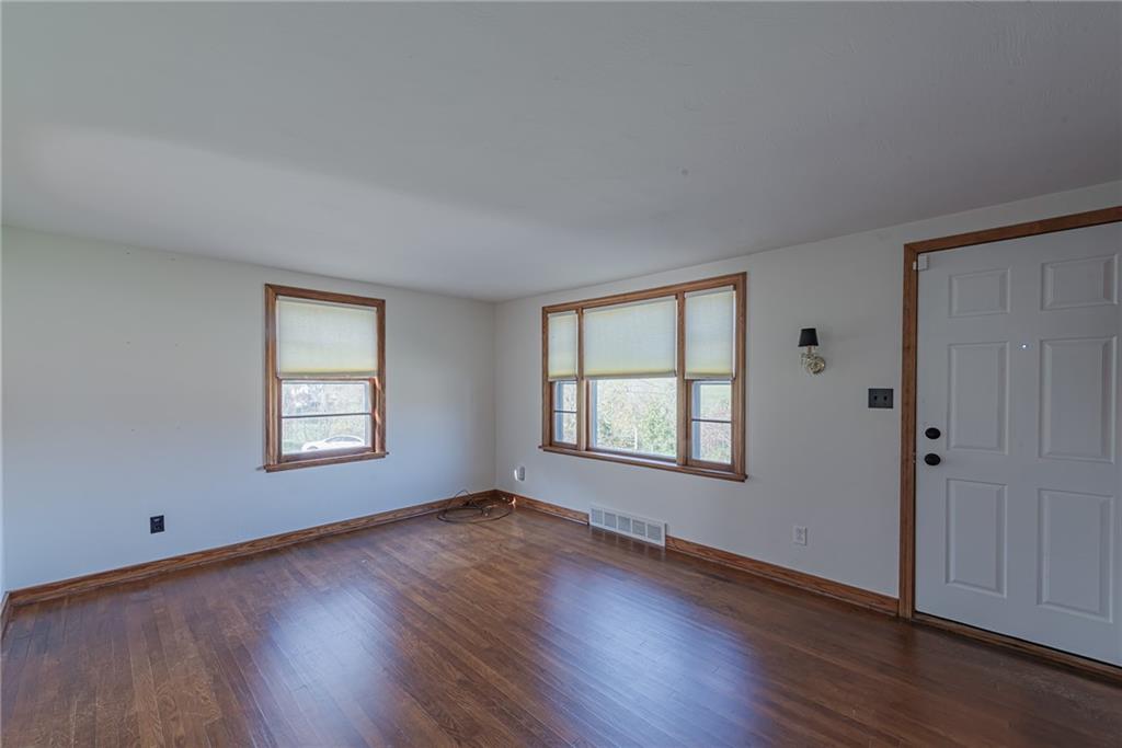 222 Maple Road Washington, PA 15301 - Photo 6 of 24 a view of an empty room with wooden floor and a window