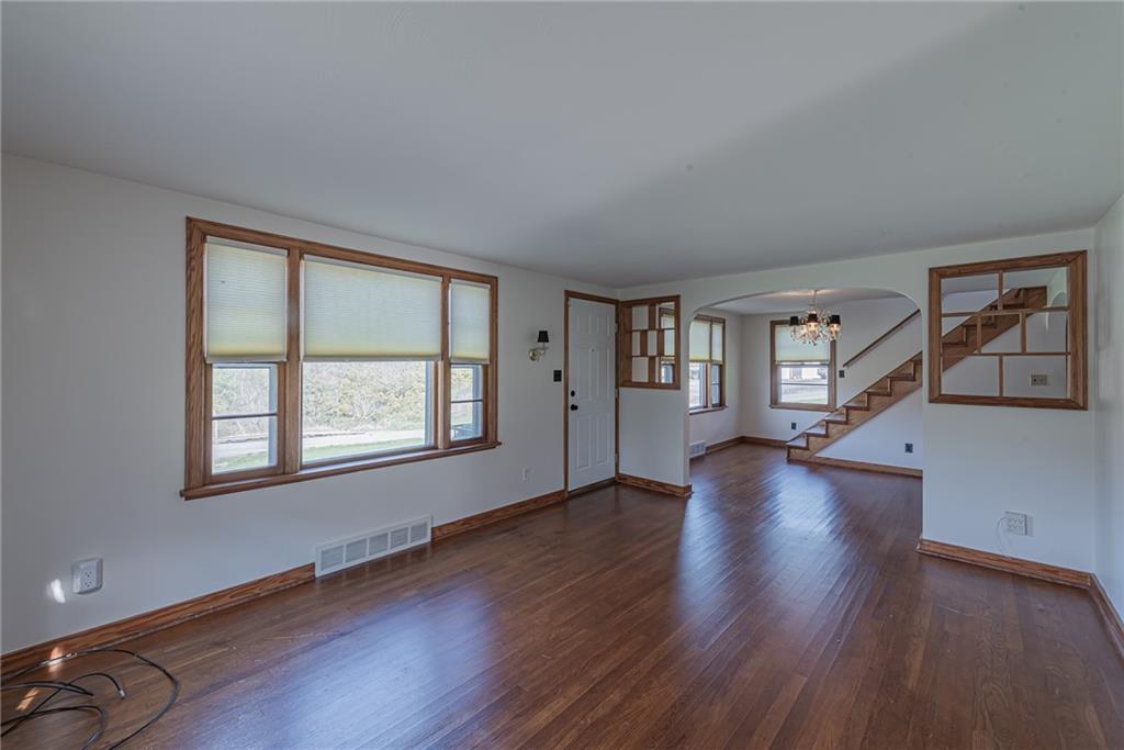 222 Maple Road Washington, PA 15301 - Photo 7 of 24 a view of an empty room with wooden floor and a window