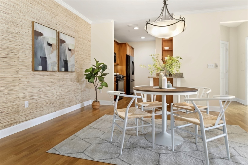 248 Albion Street, Unit 233 Wakefield, MA 01880 - Photo 11 of 39 a dining room with chandelier and wooden floor