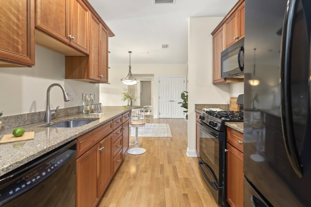 248 Albion Street, Unit 233 Wakefield, MA 01880 - Photo 19 of 39 a kitchen with stainless steel appliances granite countertop a sink stove and refrigerator