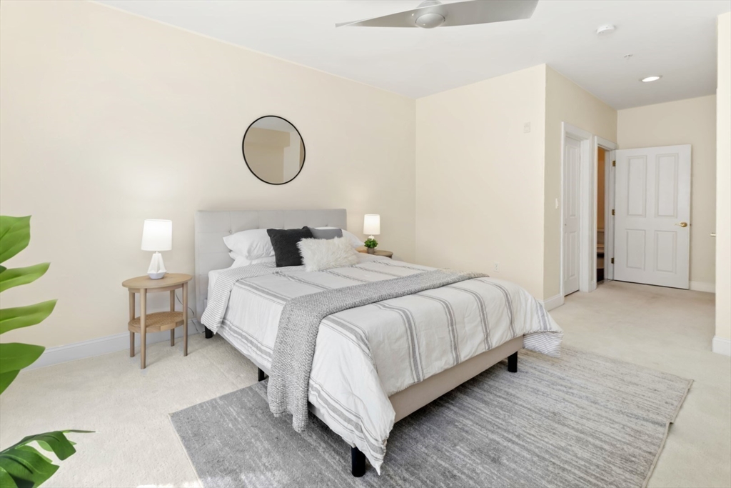 248 Albion Street, Unit 233 Wakefield, MA 01880 - Photo 23 of 39 a bedroom with a bed and lamps