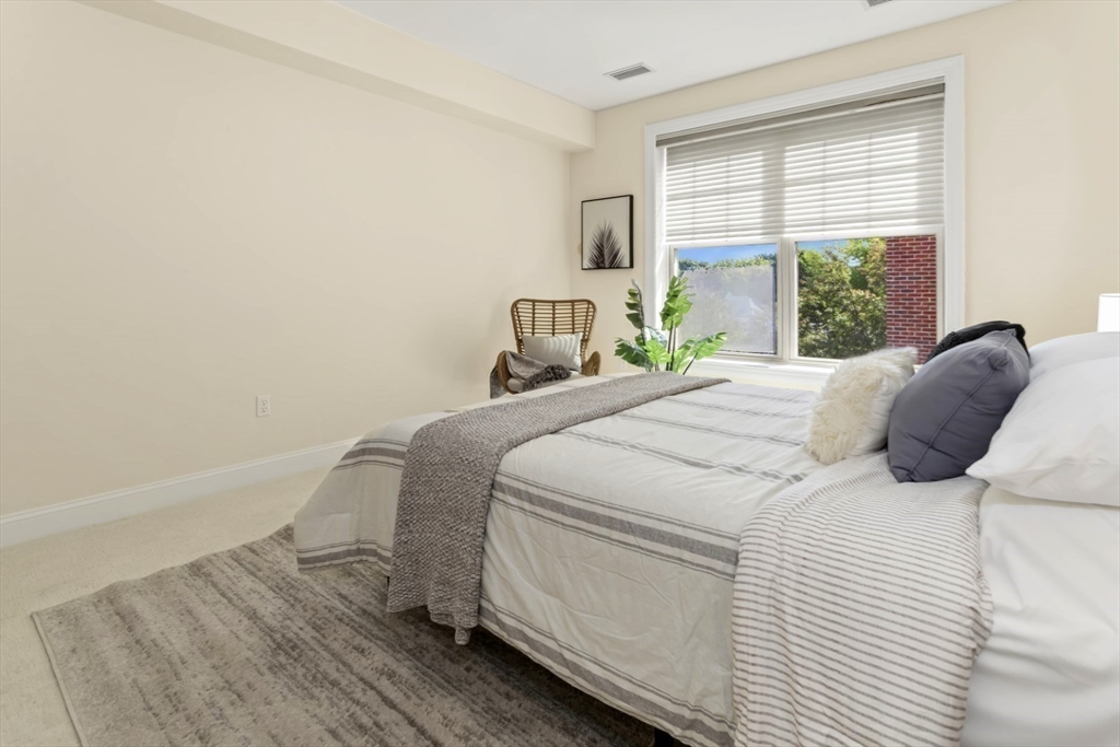 248 Albion Street, Unit 233 Wakefield, MA 01880 - Photo 24 of 39 a bedroom with a bed and a large window