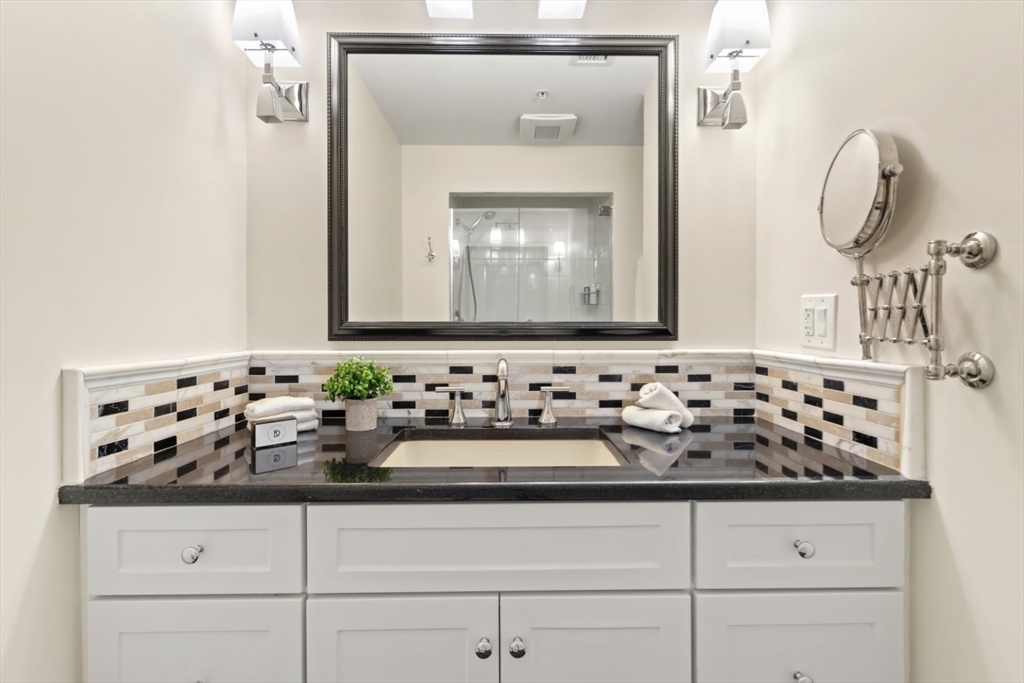 248 Albion Street, Unit 233 Wakefield, MA 01880 - Photo 27 of 39 a bathroom with a mirror sink and cabinets
