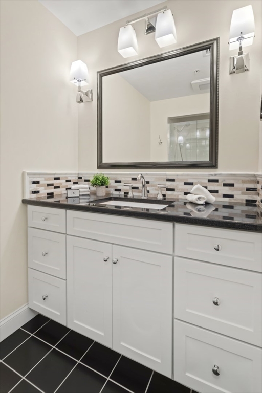 248 Albion Street, Unit 233 Wakefield, MA 01880 - Photo 28 of 39 a bathroom with a sink and a mirror