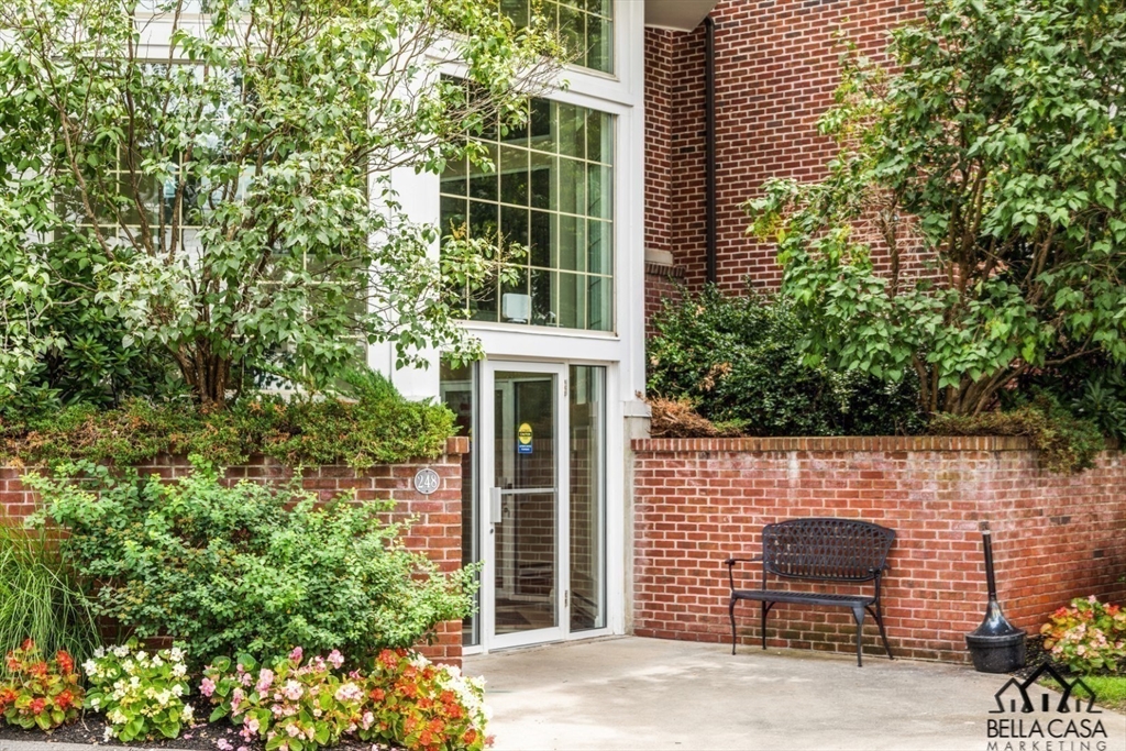 248 Albion Street, Unit 233 Wakefield, MA 01880 - Photo 3 of 39 a front view of a house with a yard