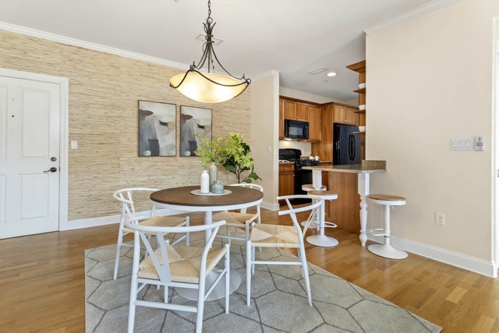 248 Albion Street, Unit 233 Wakefield, MA 01880 - Photo 9 of 39 a view of a dining room with furniture and wooden floor