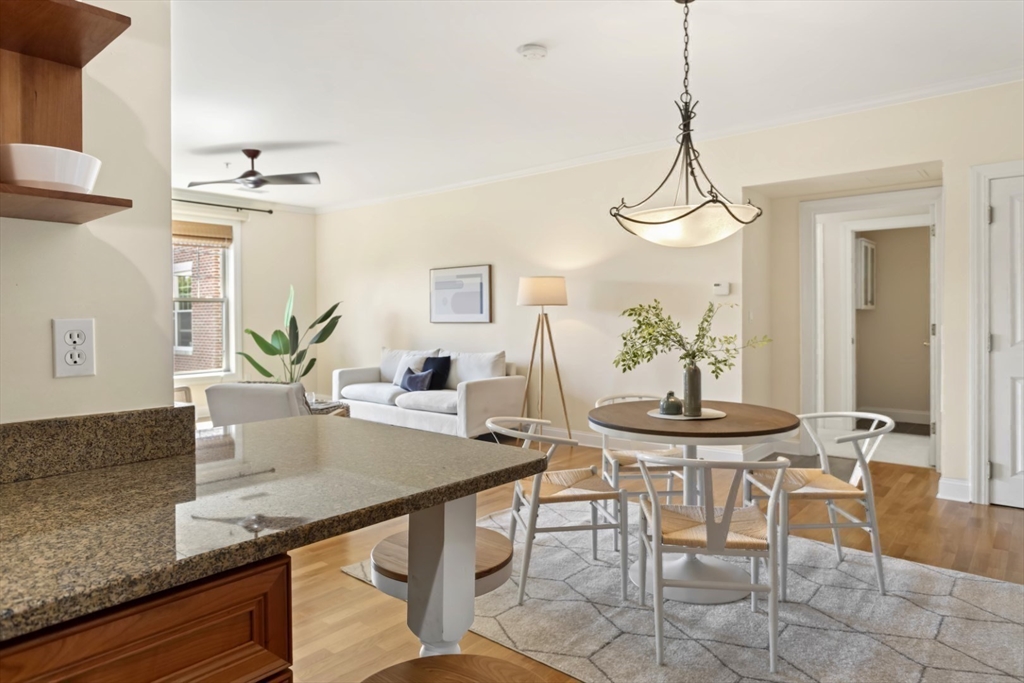 248 Albion Street, Unit 233 Wakefield, MA 01880 - Photo 10 of 39 a view of a dining room with furniture and wooden floor