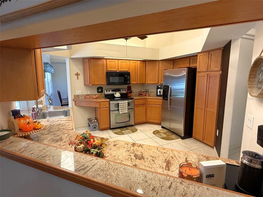 4980 Southeast 47th Terrace Road Ocala, FL 34480 - Photo 15 of 54 a kitchen with stainless steel appliances granite countertop a sink stove and refrigerator