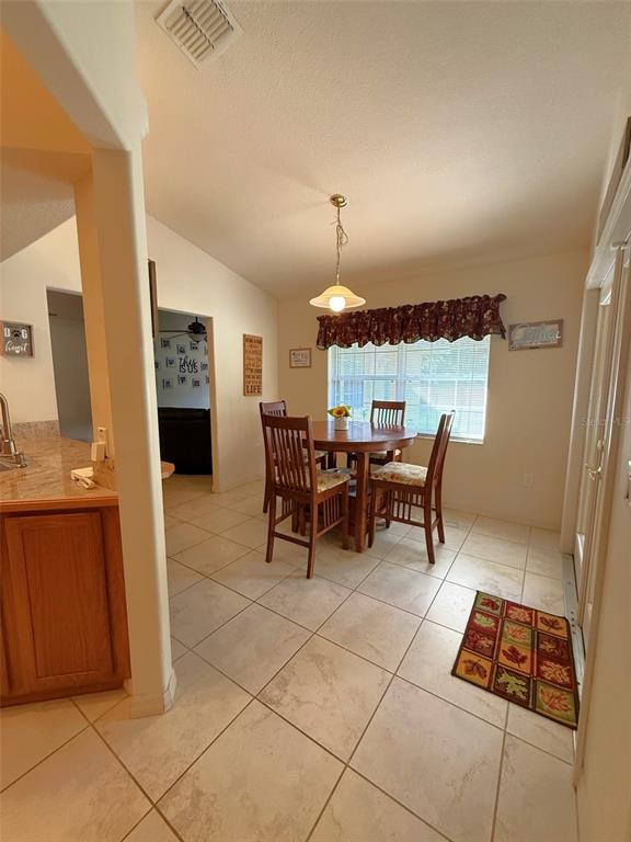 4980 Southeast 47th Terrace Road Ocala, FL 34480 - Photo 16 of 54 a view of a dining room with furniture and chandelier