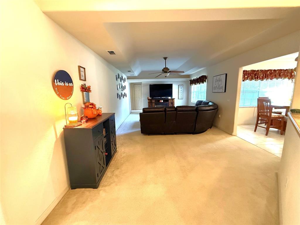 4980 Southeast 47th Terrace Road Ocala, FL 34480 - Photo 20 of 54 a living room with furniture and a flat screen tv