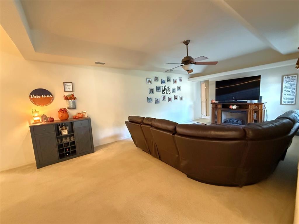 4980 Southeast 47th Terrace Road Ocala, FL 34480 - Photo 21 of 54 a living room with furniture and a chandelier
