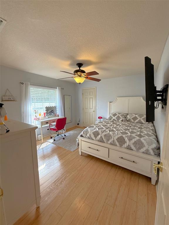 4980 Southeast 47th Terrace Road Ocala, FL 34480 - Photo 33 of 54 a bedroom with a bed and a chandelier