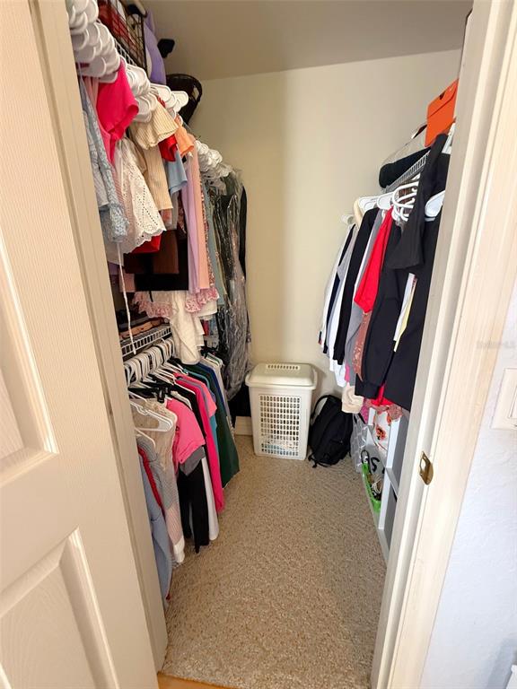4980 Southeast 47th Terrace Road Ocala, FL 34480 - Photo 35 of 54 a view of walk in closet with clothes and shoes