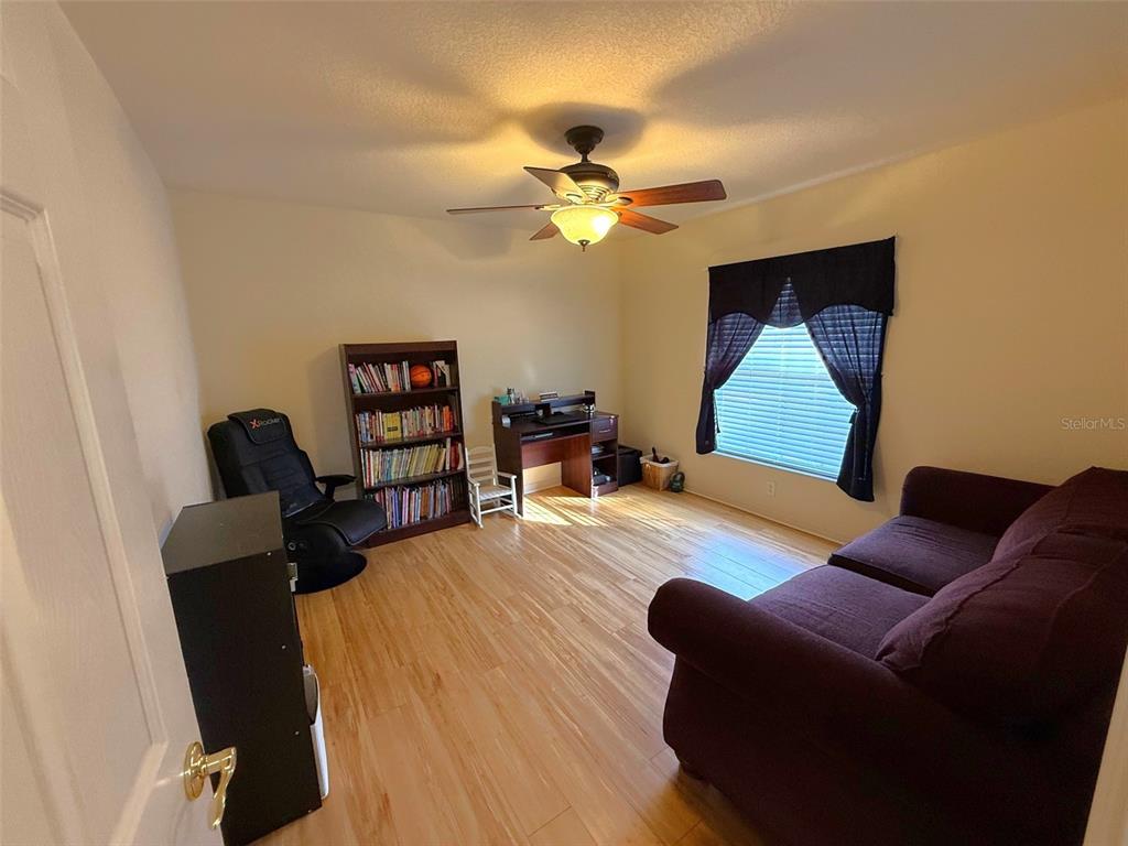 4980 Southeast 47th Terrace Road Ocala, FL 34480 - Photo 37 of 54 a living room with furniture and a wooden floor