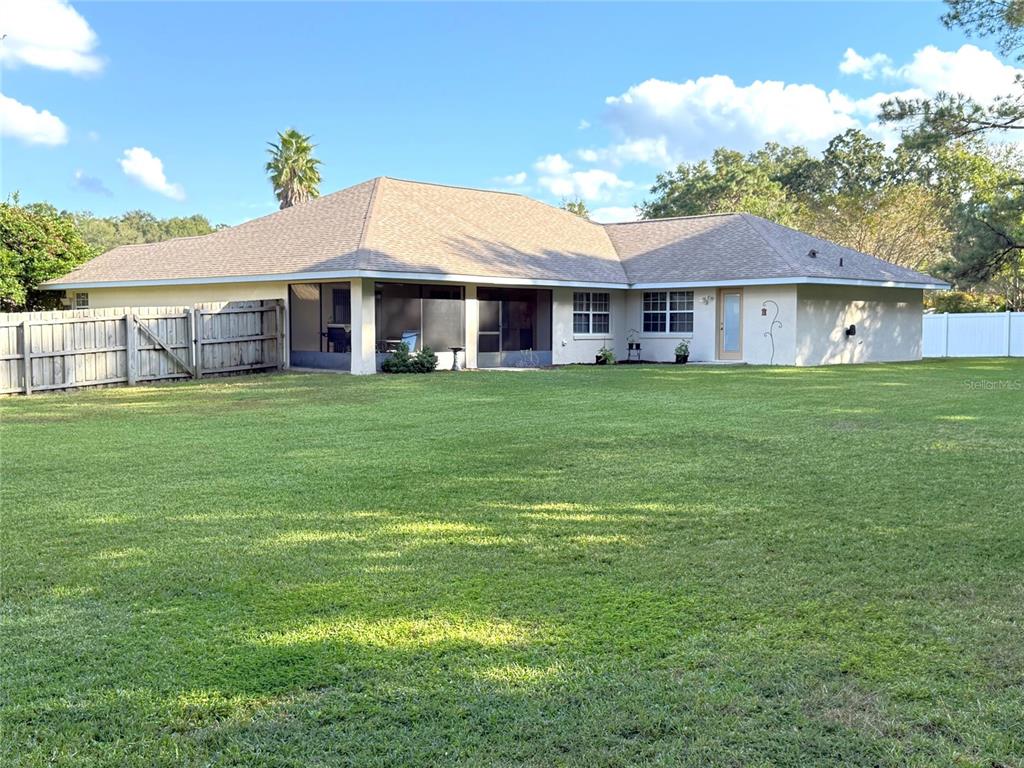 4980 Southeast 47th Terrace Road Ocala, FL 34480 - Photo 40 of 54 a front view of a house with a garden