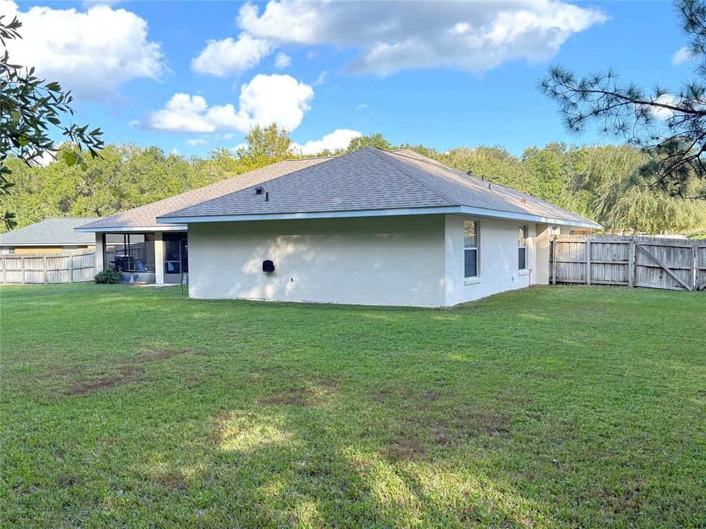 4980 Southeast 47th Terrace Road Ocala, FL 34480 - Photo 42 of 54 a front view of house with backyard and green space