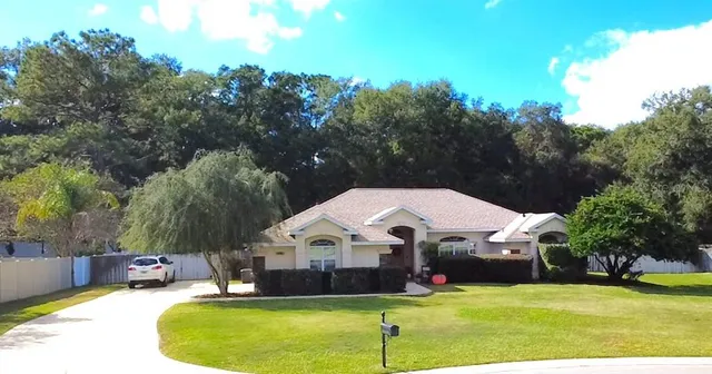 an aerial view of a house with a lake view