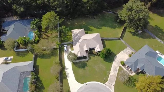 an aerial view of residential house with outdoor space and swimming pool