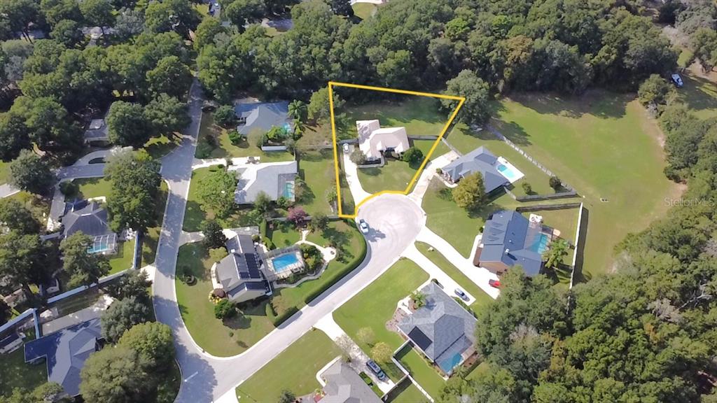 4980 Southeast 47th Terrace Road Ocala, FL 34480 - Photo 51 of 54 an aerial view of a house with swimming pool and outdoor seating