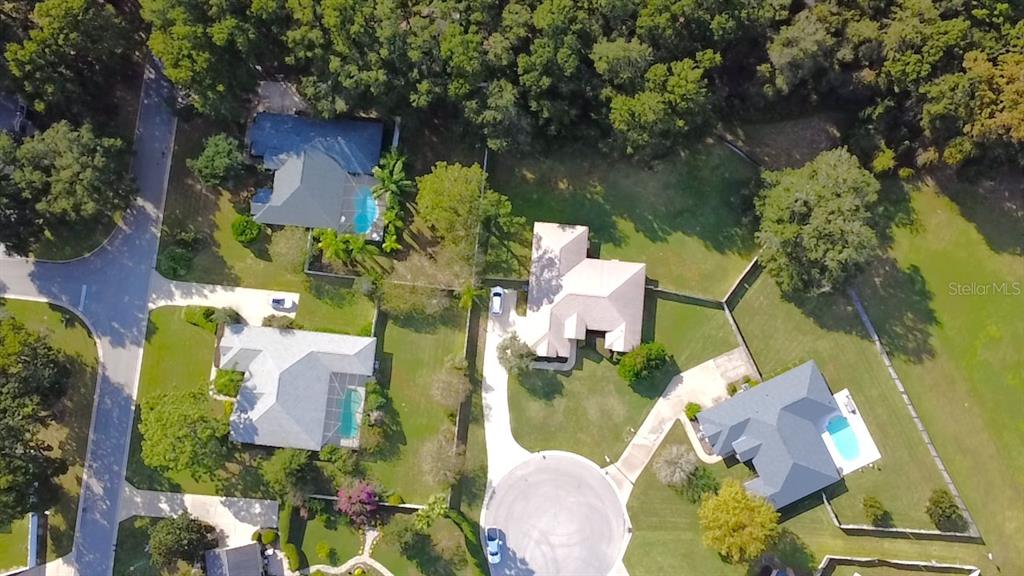 4980 Southeast 47th Terrace Road Ocala, FL 34480 - Photo 53 of 54 an aerial view of a house with outdoor space and a lake view