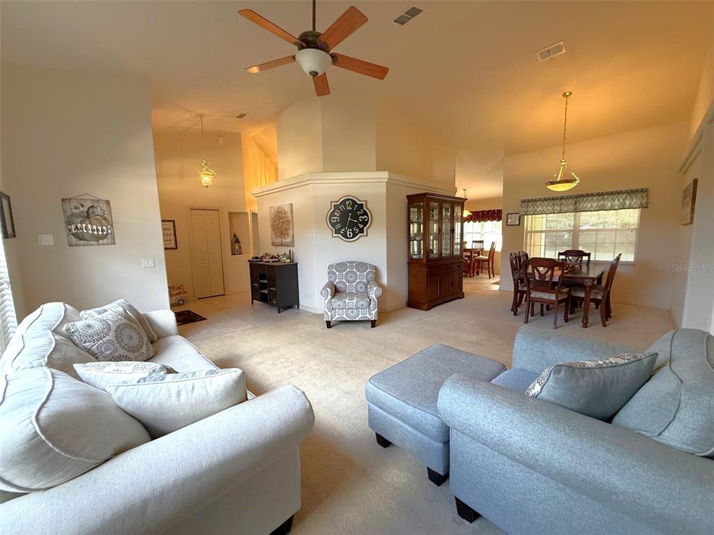 4980 Southeast 47th Terrace Road Ocala, FL 34480 - Photo 9 of 54 a living room with furniture and wooden floor